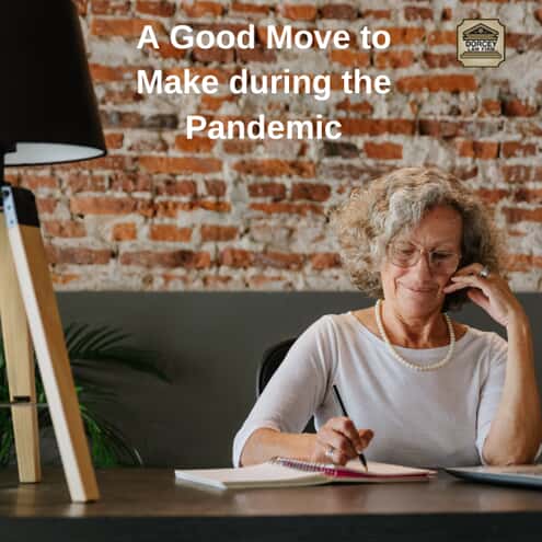 Elderly Woman Writing in a Notebook